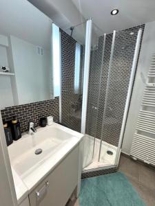a bathroom with a white sink and a shower at Residentie Peter Pan in Knokke-Heist +17 photos