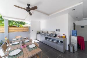 a kitchen with a dining table and a stove at Kirulhiya Omadhoo - Live the Island Dream in Omadhoo +157 photos