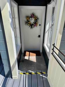 un couloir avec une porte sur laquelle est posée une couronne dans l'établissement Hike & Ski Hideaway @ Lake Placid, NY, à Lake Placid