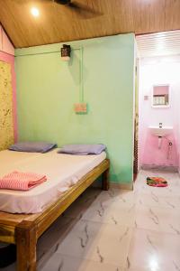 Myna beach stay في جوكارنا: غرفة صغيرة بها سرير ومغسلة