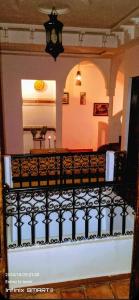 a balcony of a house with a fence at Riad La Belle Vue in Boumalne