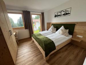 a bedroom with a bed and a large window at Wiererhof in Fügenberg