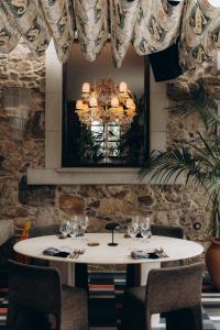 a dining room with a table and a chandelier at Casa Beatnik Country House in Santiago de Compostela +78 photos