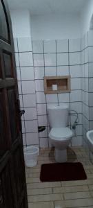 a bathroom with a white toilet and a sink at Riad La Belle Vue in Boumalne
