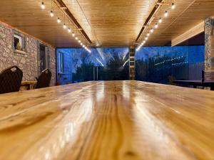 a large wooden table in a room with a mural at Nature Rock Guesthouse in Areni +18 photos