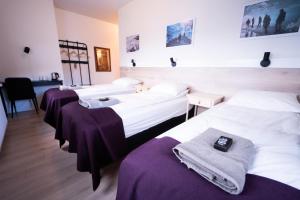 un grupo de tres camas en una habitación en Vík Inn, en Vík