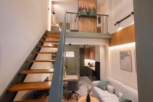 a staircase in a living room with a couch and a table at Ground Living in Volos