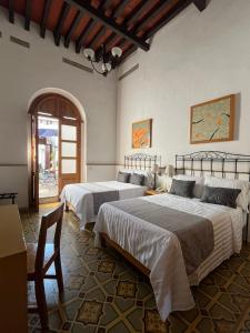 Postel nebo postele na pokoji v ubytování Quinta María Hotel Boutique & Spa