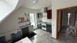 a kitchen with a sink and a stove at Adler Haus in Neunkirchen