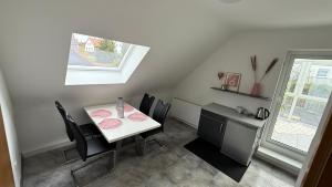 a dining room with a table and chairs and a window at Adler Haus in Neunkirchen +2 photos