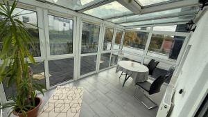 a screened in porch with a table and chairs at Adler Haus in Neunkirchen