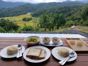 a table with plates of food and bowls of food at ดิ เอสเคป อินทนนท์ - The Escape Inthanon in Ban Yang +30 photos