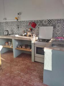 a kitchen with a stove and a sink in it at Casa Edelmira Apartment in Vallehermoso