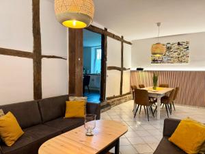 a living room with a couch and a table at Au petit Clocher - vakantiehuis Ardennen in Ferrières