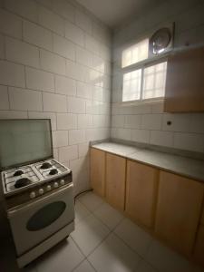 a kitchen with a stove and a window in it at أللورا زون - Alora Zone in Abha