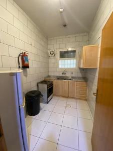 a small kitchen with a sink and a stove at أللورا زون - Alora Zone in Abha +29 photos