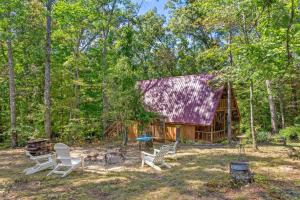 a cabin in the woods with chairs and a grill at Sugar Shack - Cave Run Lake OR Red River Gorge KY in Bangor