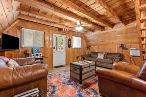 a living room with leather furniture in a cabin at Sugar Shack - Cave Run Lake OR Red River Gorge KY in Bangor