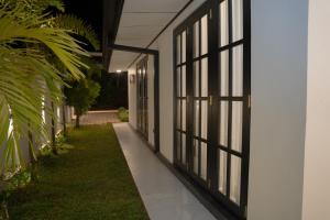 a hallway of a house with windows and grass at Cinnamon Wave Villa - Thalaramba, Mirissa in Matara