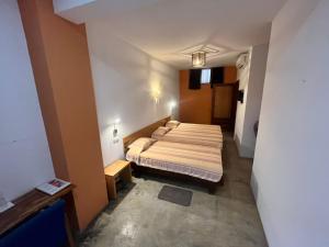 a bedroom with a bed in a small room at Residencial Che Guevara B & B Stop over in Mindelo