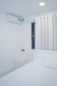 a white room with a mirror and a dresser at Cinnamon Wave Villa - Thalaramba, Mirissa in Matara