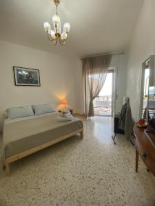a bedroom with a bed and a chandelier at Sunset Home in Bari