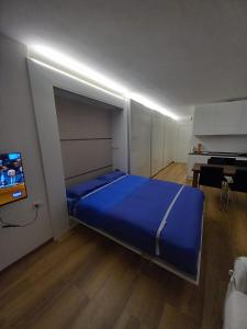 a bedroom with a bed and a flat screen tv at Appartamento Viola in Santa Caterina Valfurva
