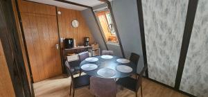 a dining room with a table and chairs at A-Frame am Ochsenkopf in Mehlmeisel