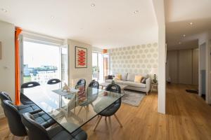 a living room with a glass table and chairs at Tipoz'immo-Maison de la Baie vue mer accès à pied - jardin clos in Penhors +28 photos