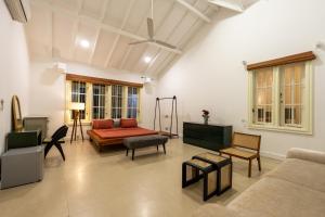a living room with a couch and a table at Hebron Gardens House in Kandy +109 photos