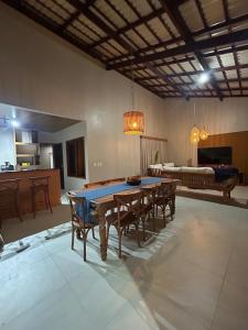 a dining room with a ping pong table and chairs at Casamares Ipioca Beach Hibiscus Maceió in Maceió