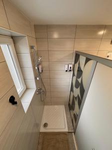 a bathroom with a shower with a glass door at RailwayRooms22 in Ljubljana