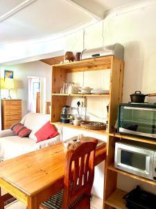 a kitchen with a wooden table and a microwave at 31 on Kloof in Aurora +18 photos