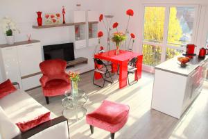 a living room with red chairs and a red table at Fun and quiet in Paris