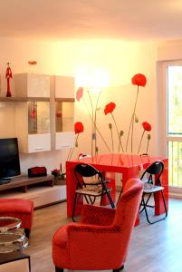 a living room with a red table and red chairs at Fun and quiet in Paris