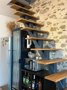 a shelving unit with wooden shelves next to a wall at Maison de ville "Chez Axel" in Les Herbiers