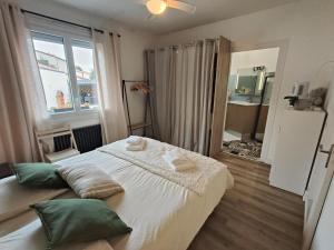 a bedroom with a bed with two pillows on it at Maison de ville "Chez Axel" in Les Herbiers