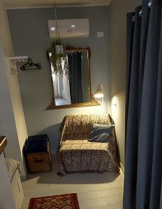a small bedroom with a bed and a mirror at Charming Holiday Home in the historic center of Pietrelcina in Pietrelcina