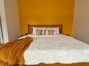a bedroom with a bed with a blanket on it at Short North Convention King Bed Free Parking! in Columbus +37 photos