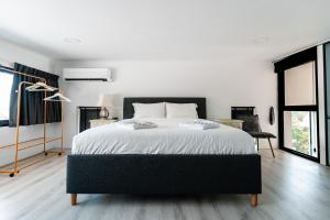 a bedroom with a large bed with white sheets at Replay R6 Pool Villa in Bophut +160 photos