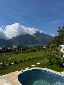 a swimming pool with a view of a mountain at Skyland Kintamani in Kubupenlokan +7 photos