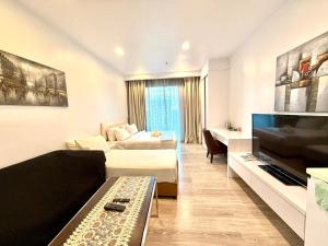 a living room with a couch and a tv at Crystal Suites at Ramad KLCC in Kuala Lumpur