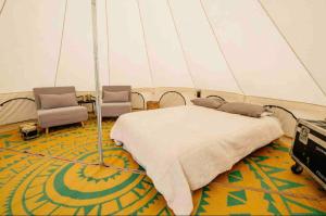 a bedroom with a bed in a tent at Piebald Mountain Pet Friendly Tents, Petersburg, New York in Pownal