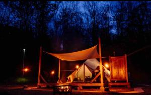 a tent with a white top at night at Piebald Mountain Pet Friendly Tents, Petersburg, New York in Pownal +11 photos