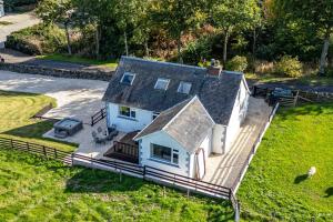 an aerial view of a white house with a deck at Satchells Cottage in Melrose