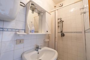 a bathroom with a sink and a mirror and a shower at Il Rifugino in Rivisondoli +14 photos