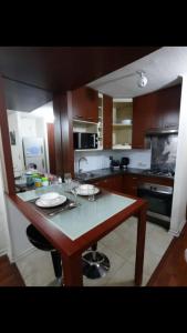 a kitchen with a large island in the middle of it at Deptos altura 562 in Santiago