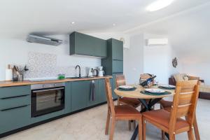 a kitchen with a table and chairs in a room at Villa Cosy in Trogir