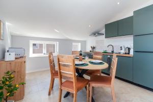 a kitchen with a table and chairs in a kitchen at Villa Cosy in Trogir
