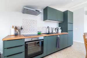 a kitchen with blue cabinets and a sink at Villa Cosy in Trogir